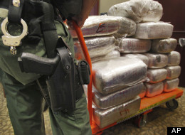 In this Nov. 4, 2010 file photo, bales of marijuana are wheeled out at a news conference in Jonesboro, Ga. Forty-five people were arrested 45 people along with cash, guns and more than two tons of drugs as part of an investigation by federal and local law enforcement into the Atlanta-area U.S. distribution hub of Mexico's La Familia drug cartel. Drug cartels have long been the nations No. 1 supplier of illegal drugs, but in the past, their operatives rarely ventured beyond the border.